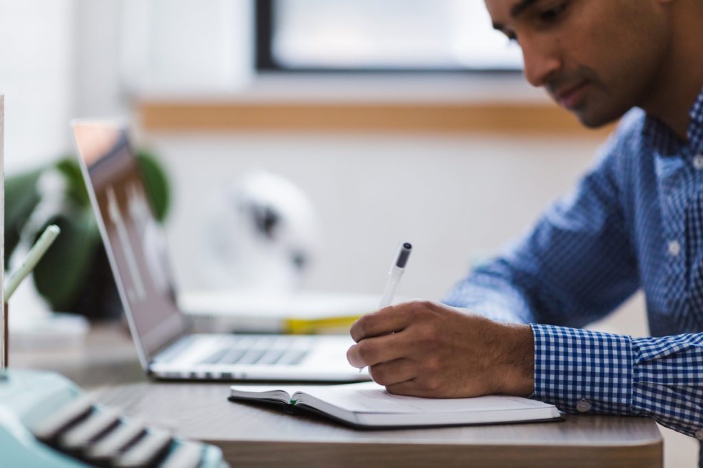 man proofreading at desk